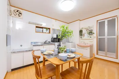 a kitchen and dining room with a table and chairs at 101 Tokyo Ikebukuro apartment near Pokemon Center in Tokyo