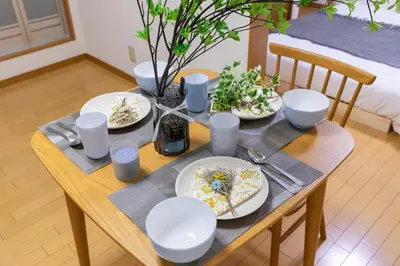 a wooden table with plates of food on it at 101 Tokyo Ikebukuro apartment near Pokemon Center in Tokyo