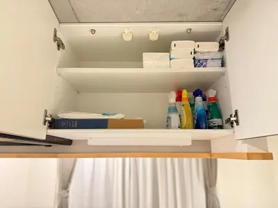 a cupboard with towels and cleaning products in it at Minami-Magome # 101 in Tokyo