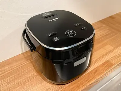 a black toaster sitting on top of a wooden table at Minami-Magome # 101 in Tokyo