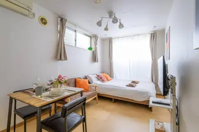 a small room with a bed and a table and a tableablish at Sakura Court Ebisu 101 in Tokyo