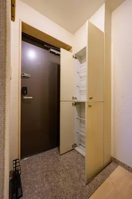 a walk in closet with a door and shelves at Sakura Court Ebisu 101 in Tokyo