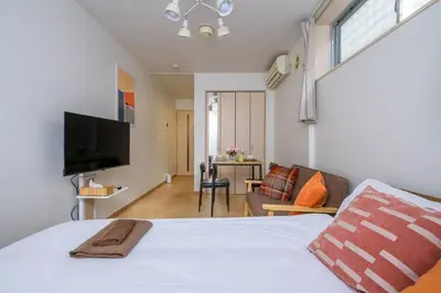 a bedroom with a bed and a living room at Sakura Court Ebisu 101 in Tokyo
