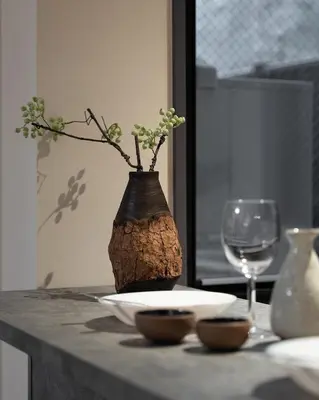 a vase on a table with a plate and a glass at F&F OMOTESANDO Designer 6LDK near Harajuku&Shibuya in Tokyo
