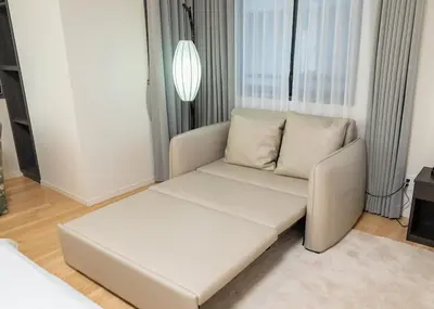a white couch in a living room with a window at F&F OMOTESANDO Designer 6LDK near Harajuku&Shibuya in Tokyo