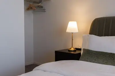 a bedroom with a bed and a lamp on a table at F&F OMOTESANDO Designer 6LDK near Harajuku&Shibuya in Tokyo