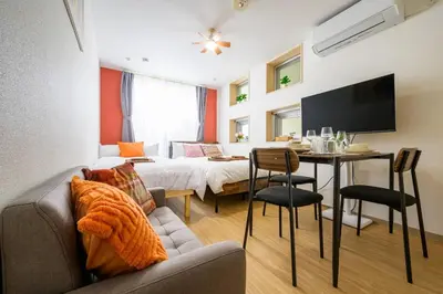 a living room with a bed and a dining room at Sakura Court Ebisu 105 in Tokyo