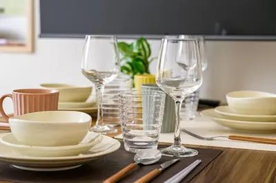 a table with two wine glasses and plates on it at Sakura Court Ebisu 105 in Tokyo
