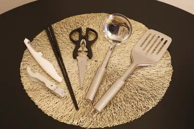 a table with a plate with scissors and other kitchen utensils at Sakura Court Ebisu 203 in Tokyo