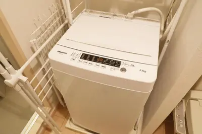 a white refrigerator in a hospital room with a box at Sakura Court Ebisu 203 in Tokyo