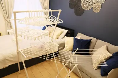 a room with a couch and a metal bed at Sakura Court Ebisu 203 in Tokyo