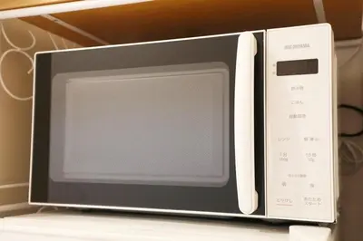 a microwave oven sitting on top of a shelf at Sakura Court Ebisu 203 in Tokyo