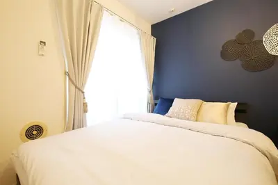 a bedroom with a white bed and a window at Sakura Court Ebisu 203 in Tokyo