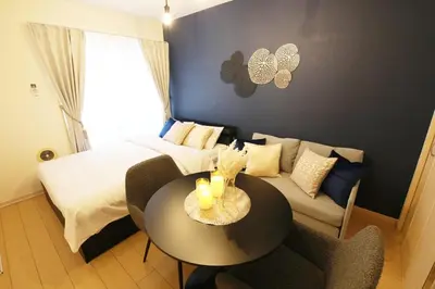 a bedroom with a bed and a table and a couch at Sakura Court Ebisu 203 in Tokyo