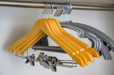 a bunch of yellow cooking utensils hanging from a rack at Sakura Court Ebisu 202 in Tokyo