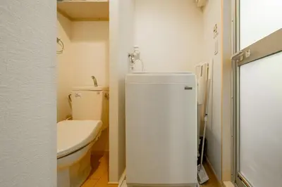 a small bathroom with a toilet and a sink at Sakura Court Ebisu 202 in Tokyo
