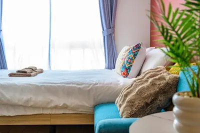a bed in a room with a couch and a window at Sakura Court Ebisu 202 in Tokyo