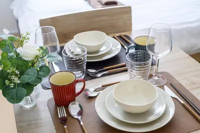 a table with plates and wine glasses on a table at Sakura Court Ebisu 202 in Tokyo