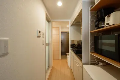 a kitchen with a stove and a microwave at Sakura Court Ebisu 205 in Tokyo