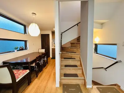 a staircase in a house with a dining room and a table at Skytree Detached Home in Tokyo