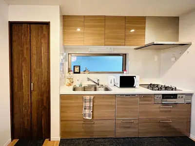 a kitchen with a sink and a microwave at Skytree Detached Home in Tokyo