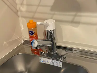 a kitchen sink with a mixer and a bottle on it at \u4e1c\u4eac\u90fd\u5185\u5bbe\u9986Nexus villa in Tokyo