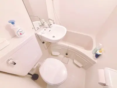 a white bathroom with a toilet and a sink at 308, Shinjuku City, JR Yamanote Line, 6 min walk to Takadanobaba stn in Tokyo