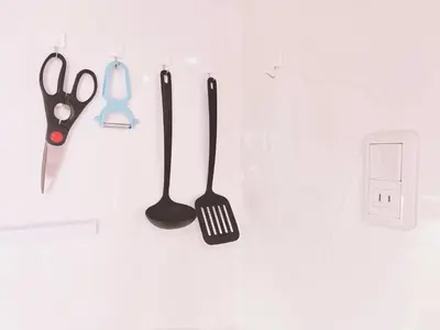 a group of kitchen utensils hanging on a wall at 308, Shinjuku City, JR Yamanote Line, 6 min walk to Takadanobaba stn in Tokyo