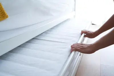 a person is holding a rail on a bed at Sgc\u4e16\u7530\u8c371\u4e01\u76ee in Tokyo