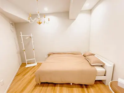 a bedroom with a bed and a chandelier at Season Hotel \u65b0\u5c0f\u5ca9 in Tokyo