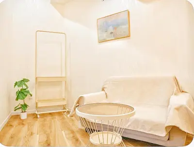 a living room with a couch and a table at Season Hotel \u65b0\u5c0f\u5ca9 in Tokyo