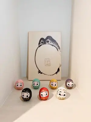 a box filled with different colored cupcakes next to a picture at Skytree Area Top-Tier Luxury, 6 min Walk to Station,Stay in a Traditional Japanese Ukiyo-e Art Villa with Rooftop, 6 min to Tokyo Skytree, Sleeps 12, 99sqm New Build, Parking, Direct Airport Access, Tokyo Experience in Tokyo