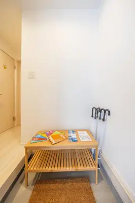 a wooden bench sitting next to a wall at Skytree Area Top-Tier Luxury, 6 min Walk to Station,Stay in a Traditional Japanese Ukiyo-e Art Villa with Rooftop, 6 min to Tokyo Skytree, Sleeps 12, 99sqm New Build, Parking, Direct Airport Access, Tokyo Experience in Tokyo