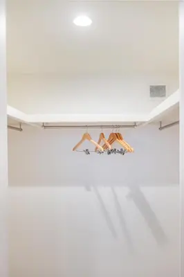 a shelf in a white room with hangers at Skytree Area Top-Tier Luxury, 6 min Walk to Station,Stay in a Traditional Japanese Ukiyo-e Art Villa with Rooftop, 6 min to Tokyo Skytree, Sleeps 12, 99sqm New Build, Parking, Direct Airport Access, Tokyo Experience in Tokyo