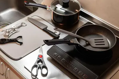 a frying pan on top of a stove with scissors at Sakura Court Ebisu 303 in Tokyo