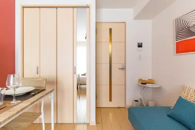 a living room with a door leading to a bathroom at Sakura Court Ebisu 303 in Tokyo