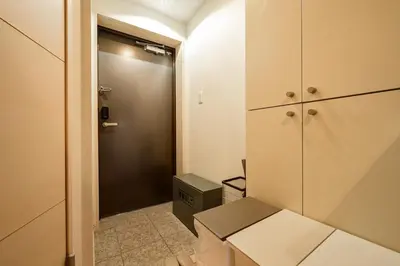 a small bathroom with a closet and a door at Sakura Court Ebisu 303 in Tokyo
