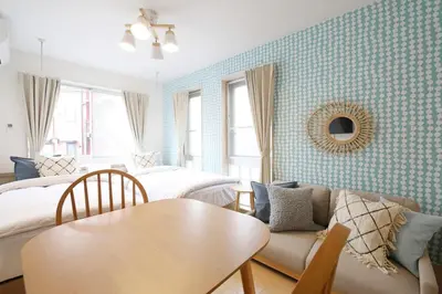 a room with a bed and a table and a couch at Sakura Court Ebisu 305 in Tokyo