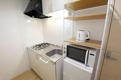 a small kitchen with a sink and a microwave at Sakura Court Ebisu 305 in Tokyo