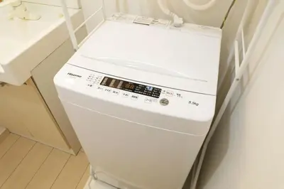 a white dishwasher in a bathroom next to a sink at Sakura Court Ebisu 305 in Tokyo