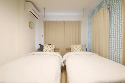 two beds sitting next to each other in a room at Sakura Court Ebisu 305 in Tokyo