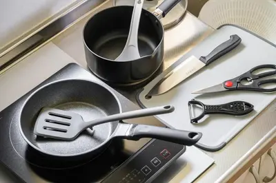 a frying pan with a spatula on top of a stove at Sakura Court Ebisu 401 in Tokyo