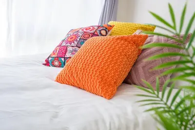 a group of pillows sitting on top of a bed at Sakura Court Ebisu 401 in Tokyo