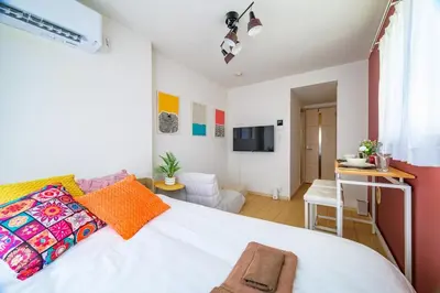 a bedroom with a white bed and a desk at Sakura Court Ebisu 401 in Tokyo