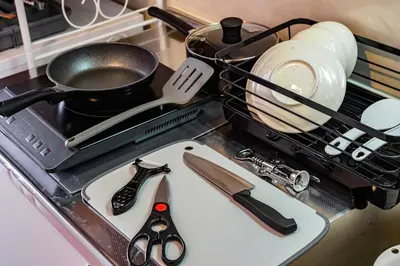 a drying rack with scissors and a pot on a stove at Sakura Court Ebisu 402 in Tokyo