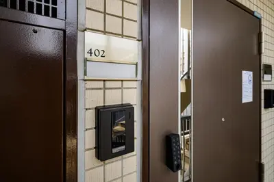 a door with a pay meter on a wall at Sakura Court Ebisu 402 in Tokyo