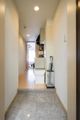 a hallway with a toilet and a kitchen at Sakura Court Ebisu 402 in Tokyo