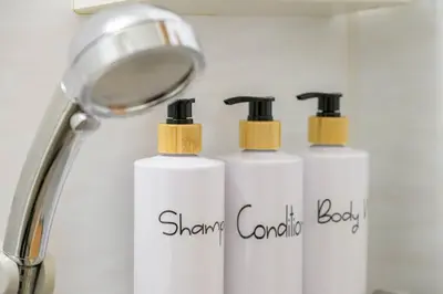 two white shampoo bottles sitting next to a magnifier at Sakura Court Ebisu 403 in Tokyo