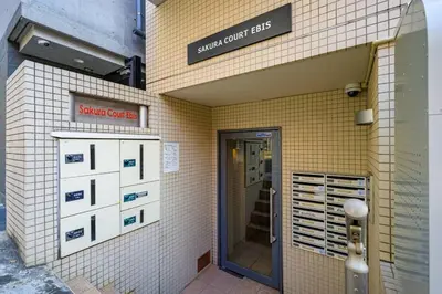 a building with a sign that reads smart curb bites at Sakura Court Ebisu 403 in Tokyo