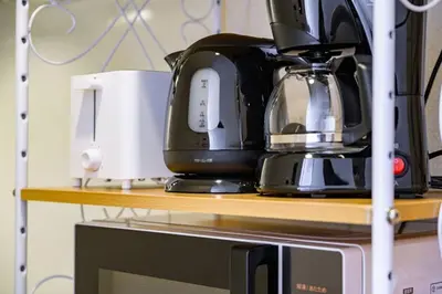 a coffee maker is sitting on top of a microwave at Sakura Court Ebisu 405 in Tokyo